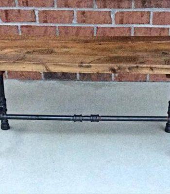 repurposed pallet and black iron pipe bench