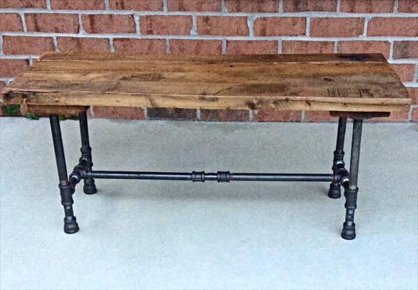 repurposed pallet and black iron pipe bench