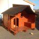 wooden pallet dog house with chevron shingled roof